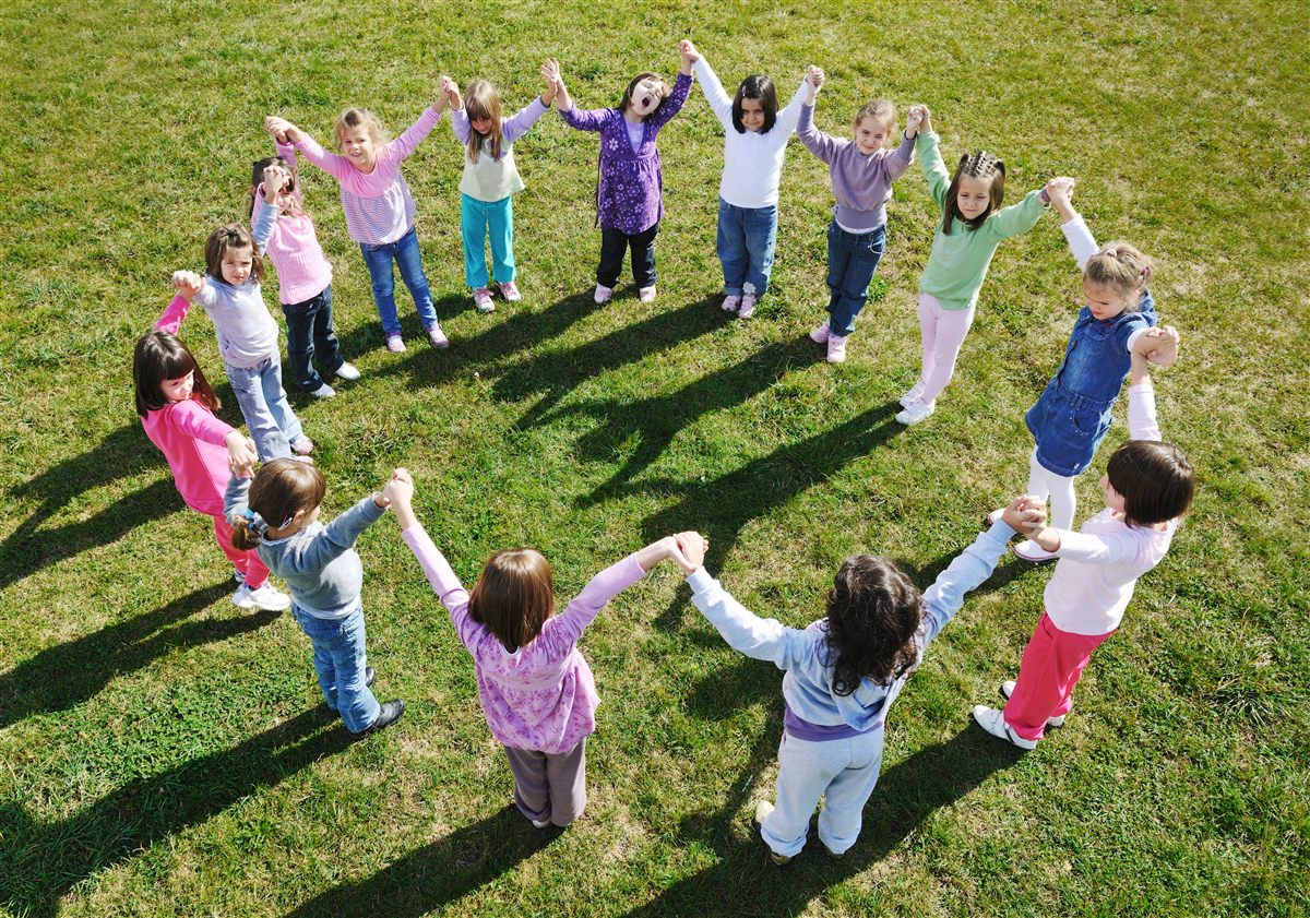 Children holding hands in a circle at a Burbank park